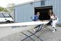 Staff member Maureen Boyd and Jacqueline Harris ´83 carry a boat out to the water.<em><span style=font-size:9pt;>&nbsp;Credit: A. Vincent Scarano</span></em>