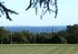 A view from Tempel Green, with New London steeples and sailboats on the horizon.