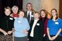 History Professor Marc. R. Forster poses with alumni at the College for a Day program in Denver in January.