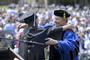 President Lee Higdon congratulates a member of the Class of 2012.<em><span style=font-size:9pt;>&nbsp;Credit: Jon Crispin</span></em>