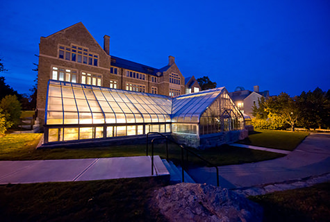 The greenhouse outside New London Hall at night.