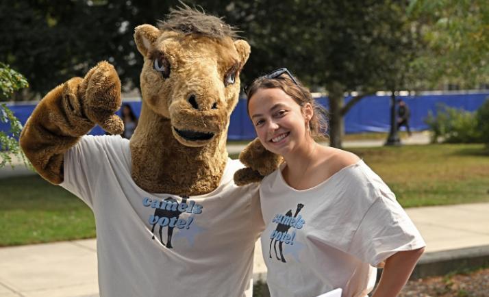 Student with the Conn mascot