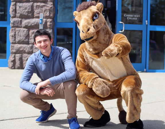 Student posing with the camel outside of Cro