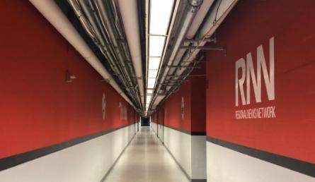 A red hallway with the RNN logo. 
