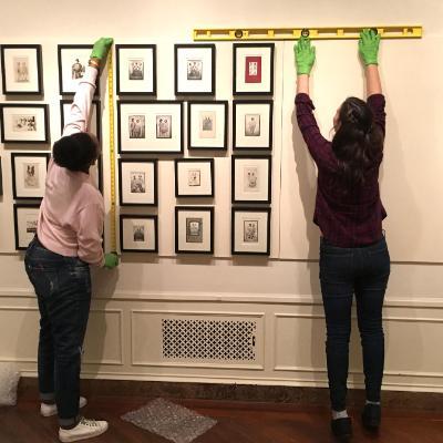 Students building an exhibition of prints