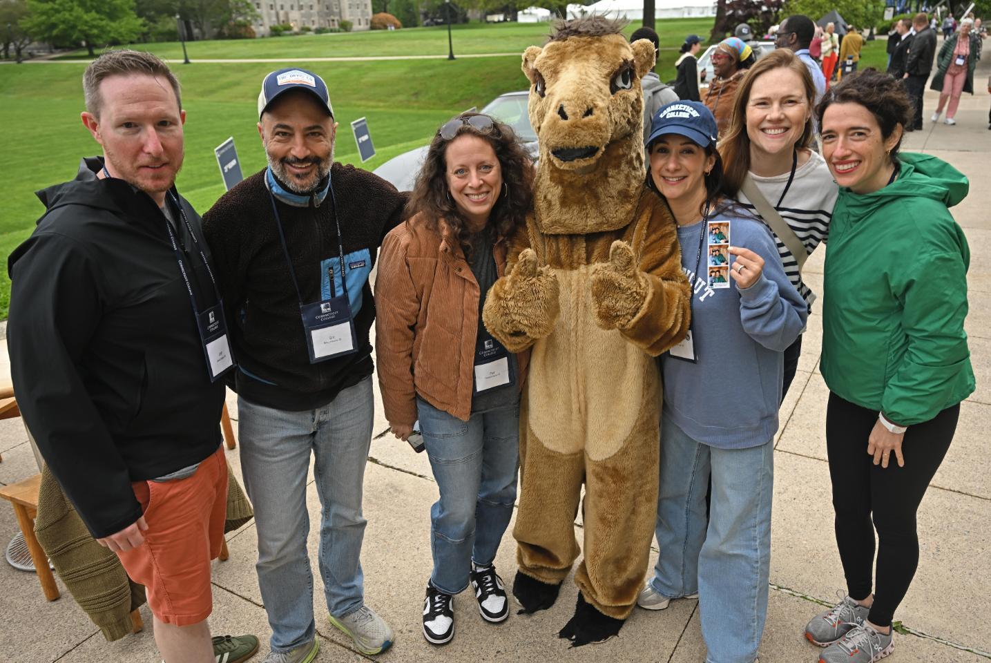 People at reunion posing with the camel mascot