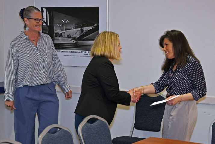 Merrill Collins and President Andrea Chapdelaine give Rebecca McCue the Service Excellence Award.