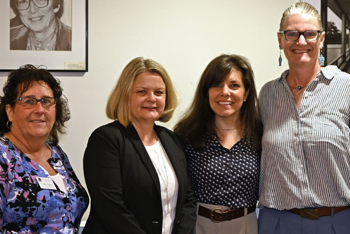 Lynne Crider, President Andrea Chapdelaine, Rebecca McCue, and Merrill Collins pose for a photo after awarding McCue the Service Excellence Award.