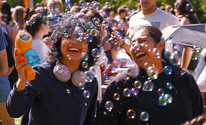 Students playing with a bubble machine