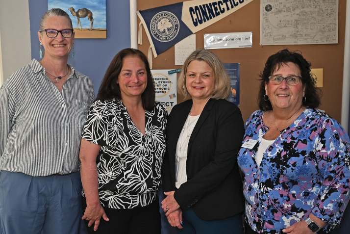 Merrill Collins, Stacey Flynn, President Andrea Chapdelaine, and Lynne Crider pose for a photo after awarding Flynn's Innovation Award.