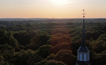An aerial photo of campus from the chapel looking out over the green of the arboretum.