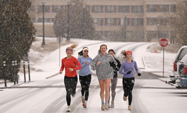 Students running in the snow
