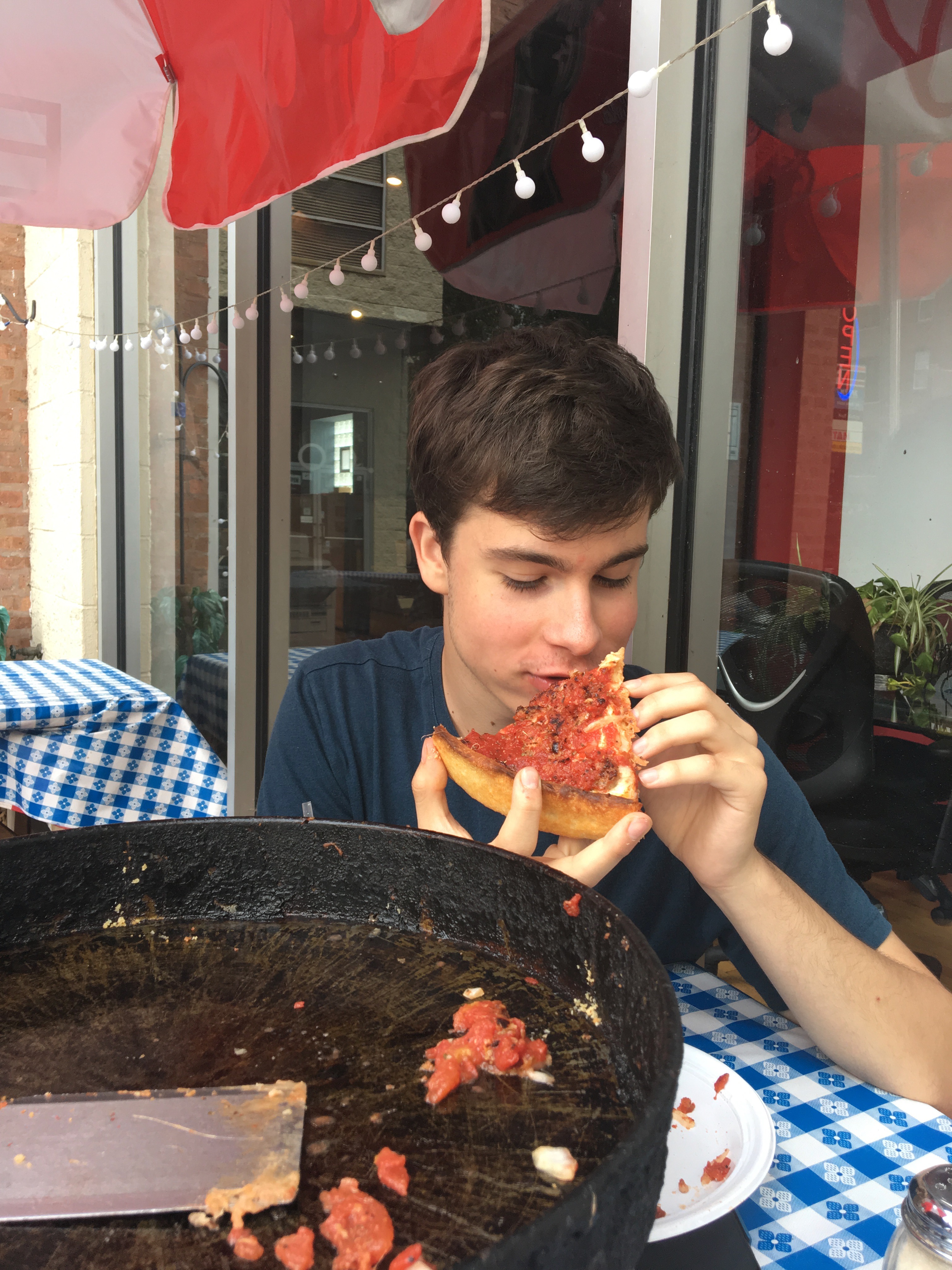 Samuel eats the last slice of deep dish pizza. 