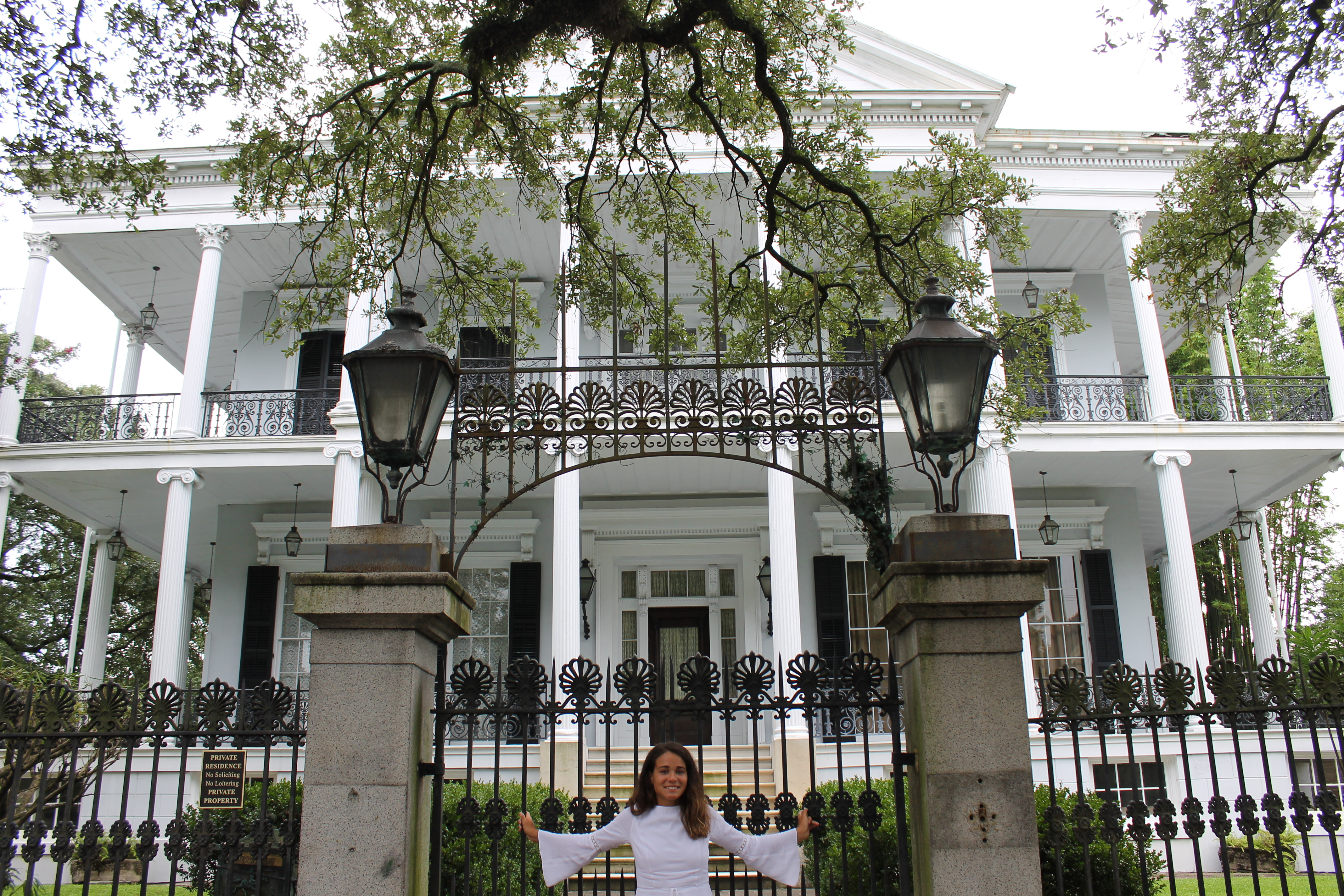Dani poses in front of the mansion featured in the television series American Horror Story.