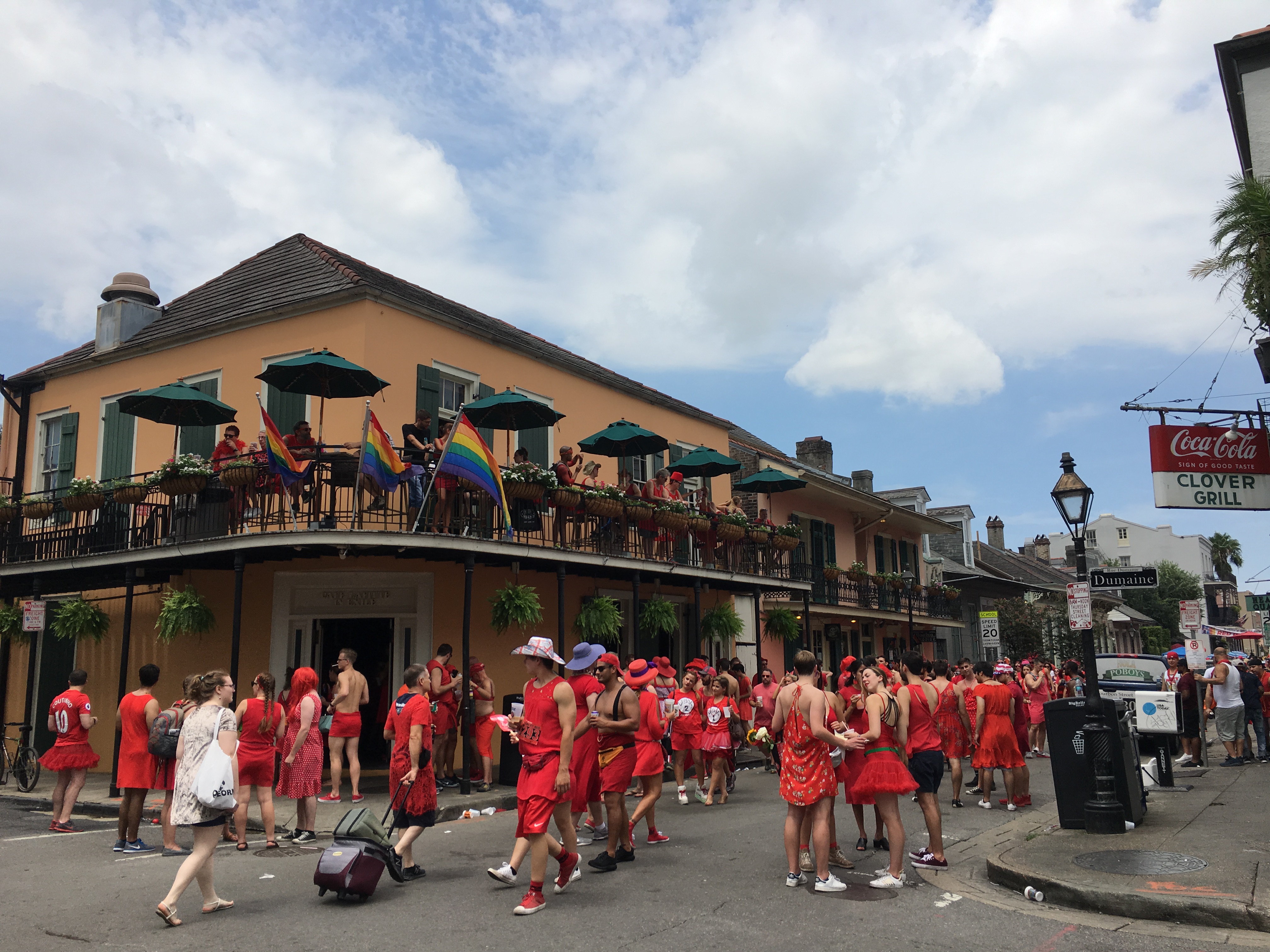 Male and female runners done red dresses in the streets of New Orleans for the annual Red Dress Run.