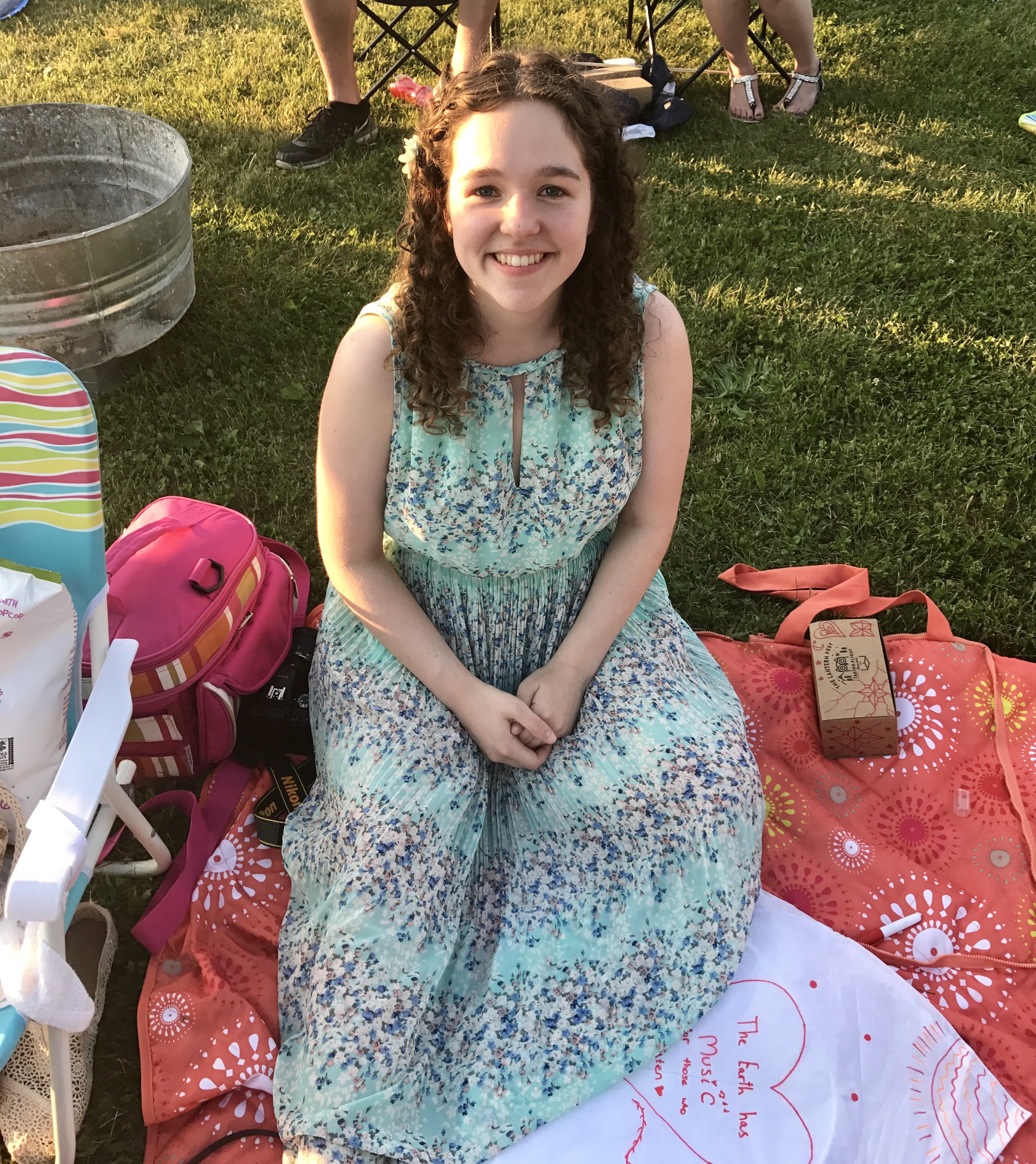 Student Ashley Myers relaxes on a picnic blanket.