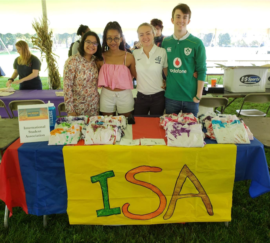 Samirah poses with members of the International Student Association's table at Harvestfest