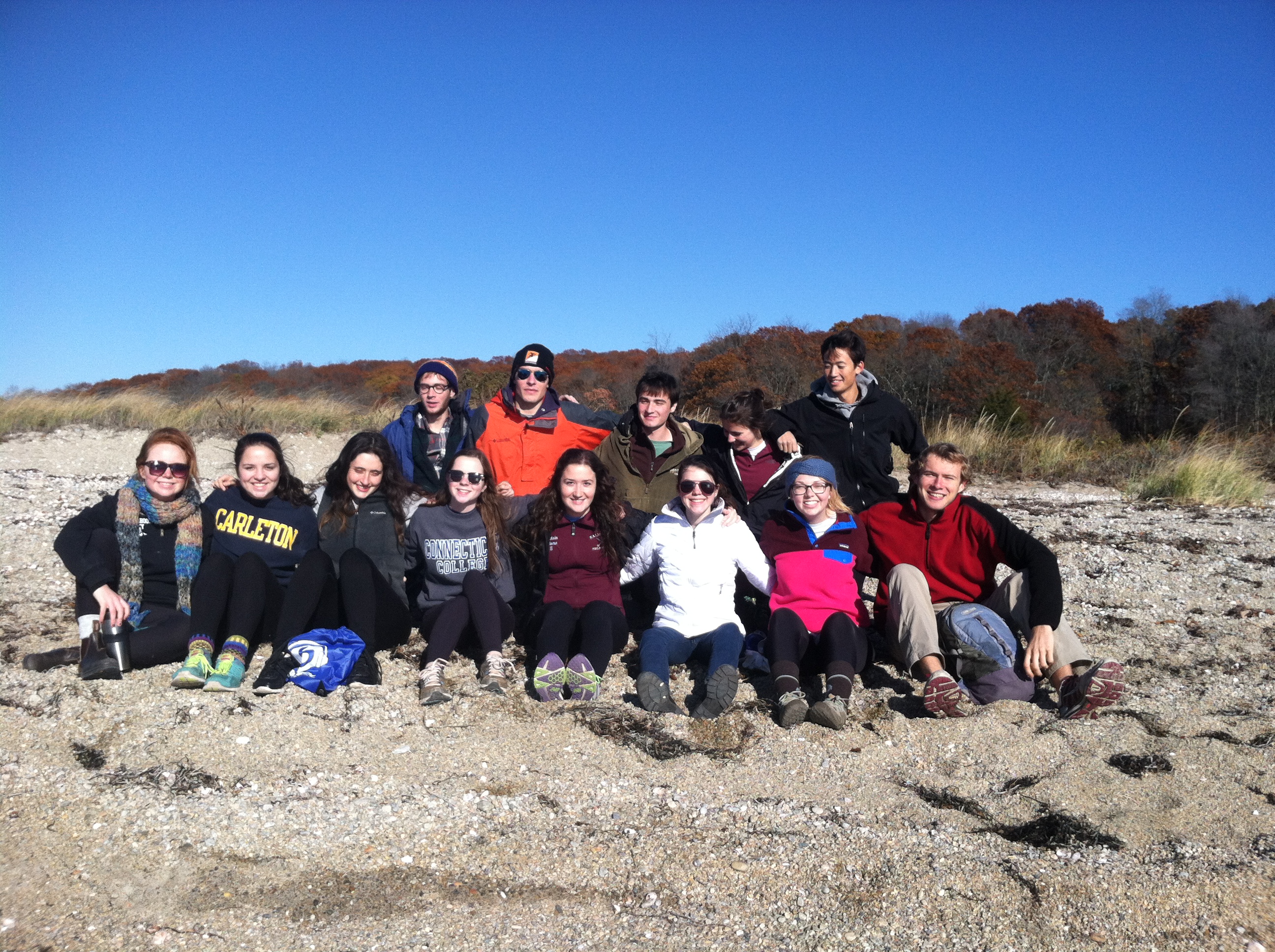 A group of students from the Outdoors Club pose along a beach at Bluff Point, CT. 