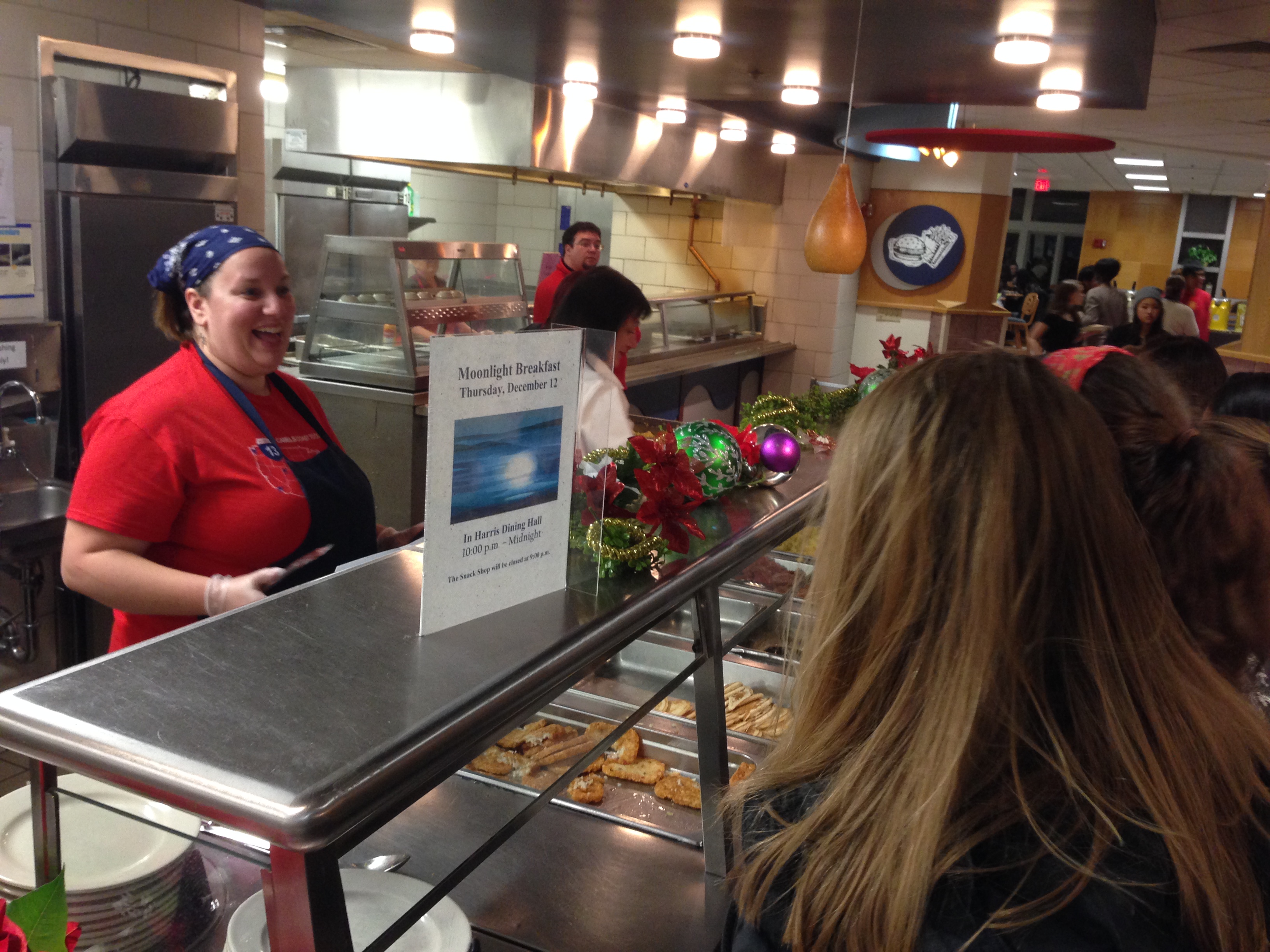 Director of Residential Education and Living serves food to students