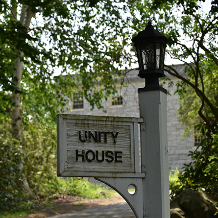 Unity House wooden sign.