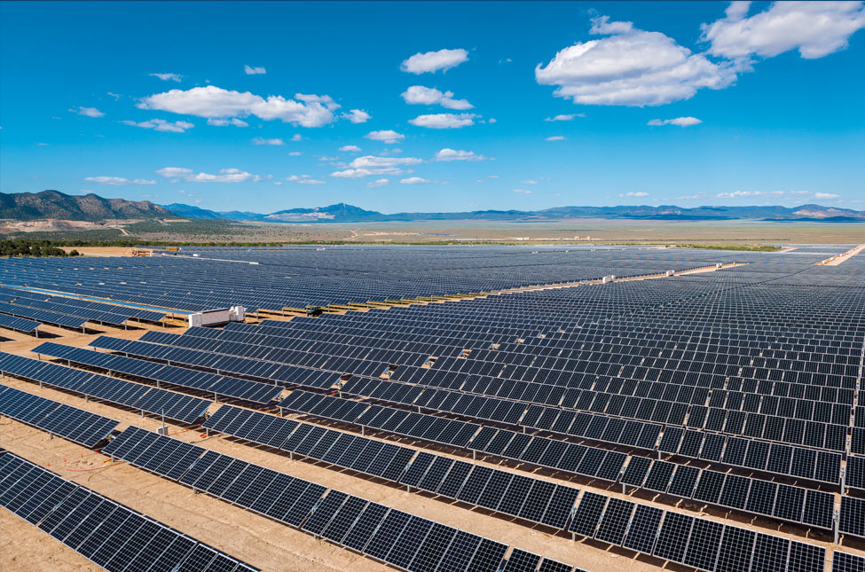 A huge field of solar panels rests in the hills