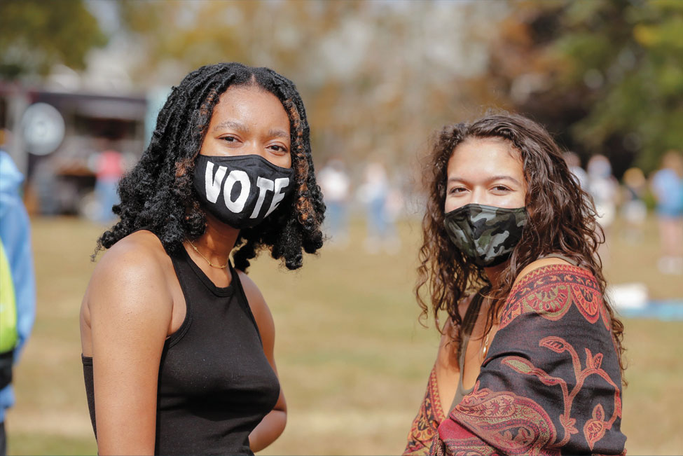 Close-up of two female students wearing masks on campus