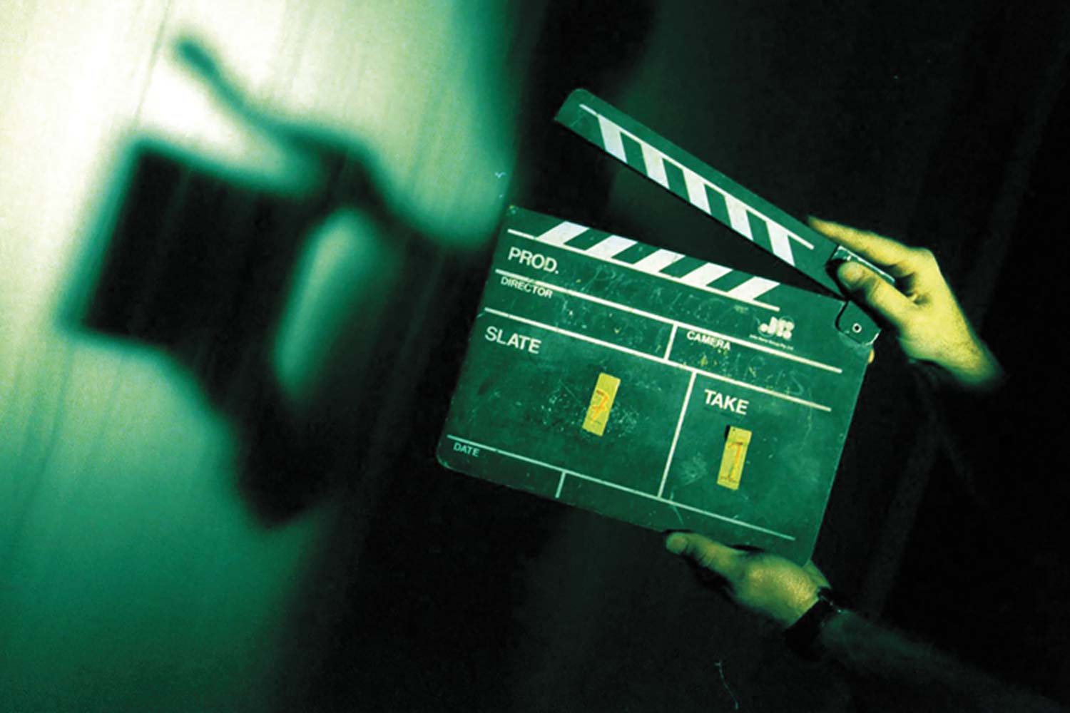 Image of hands on movie clappers