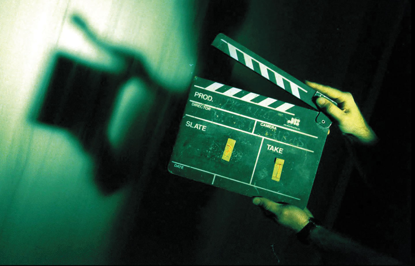 Image of hands on movie clappers