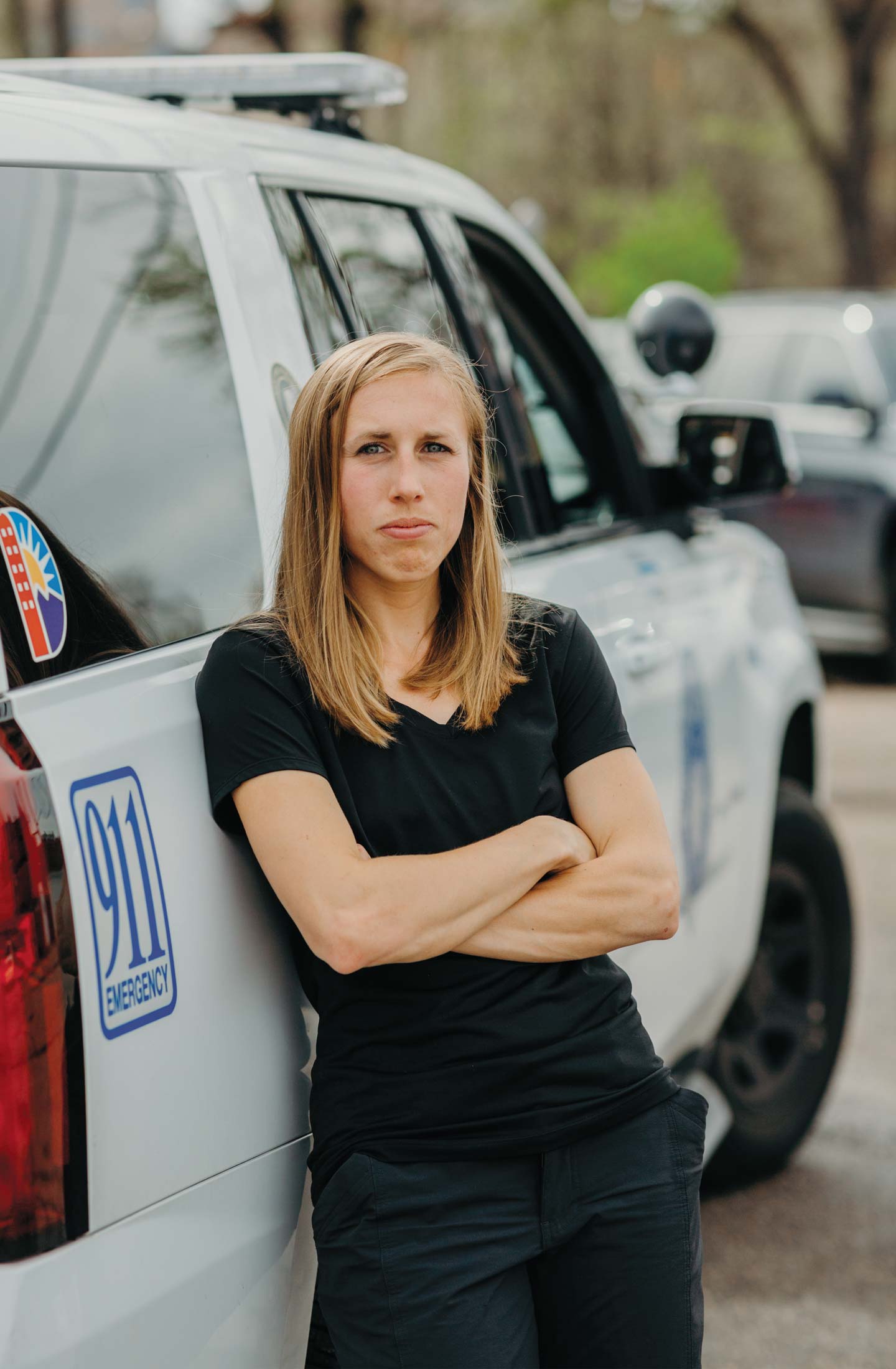 Image of Kathy Evans ’14 standing by a patrol car