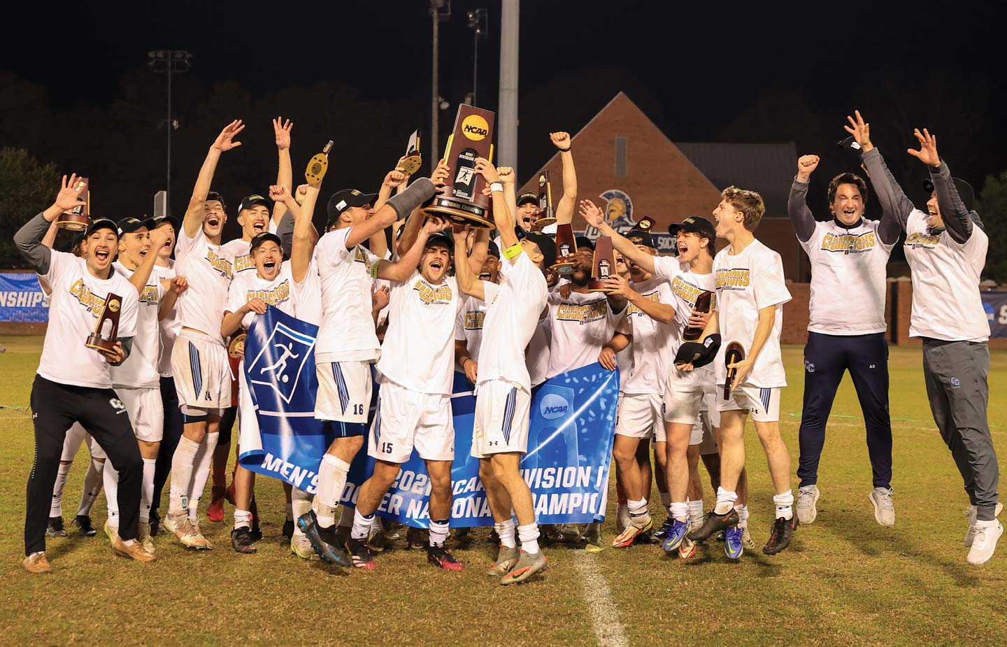 The men’s team celebrates at UNCG Soccer Stadium after the College’s first-ever national championship win.