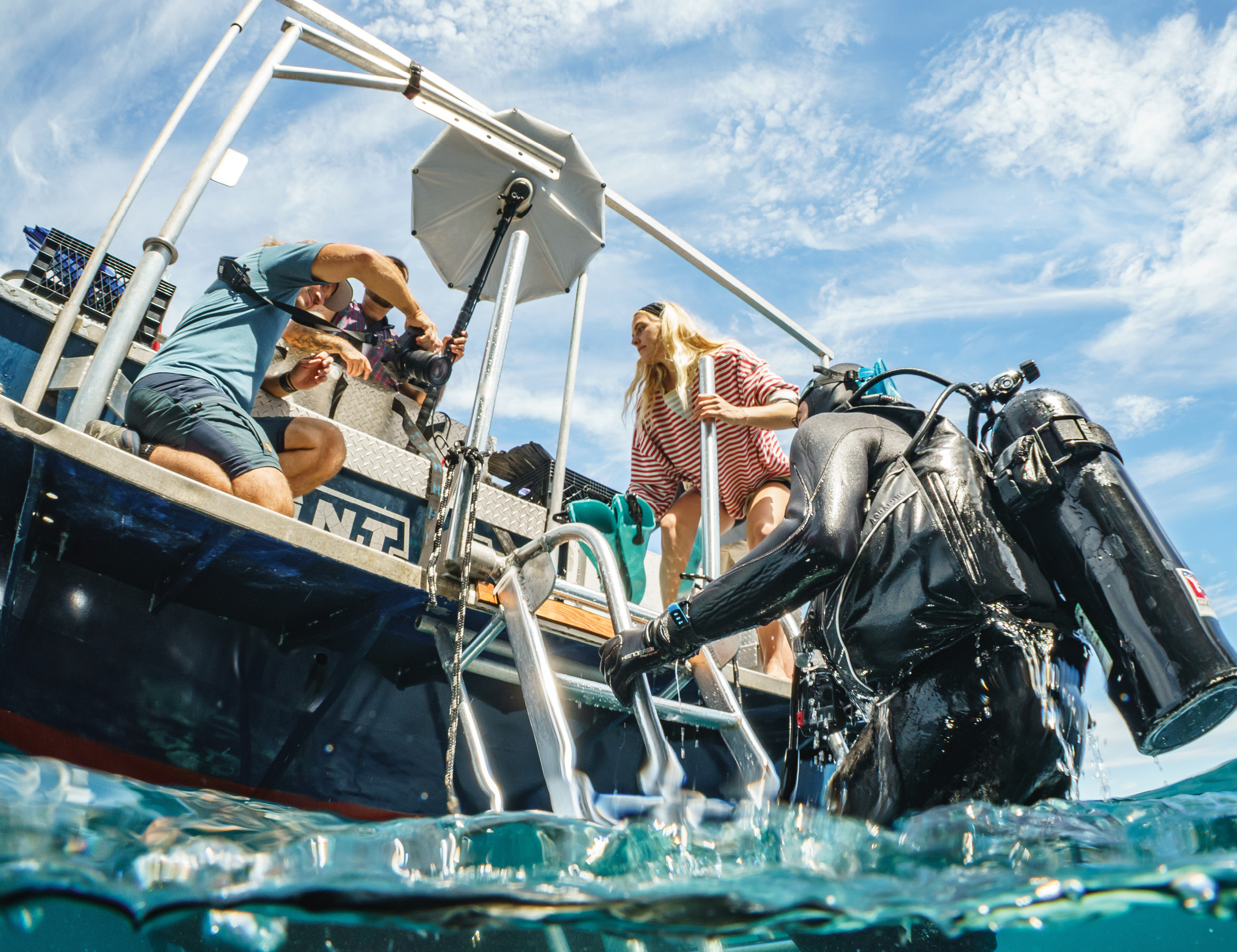 Jamie Sussman ’26 in diving gear climbing onto a boat.