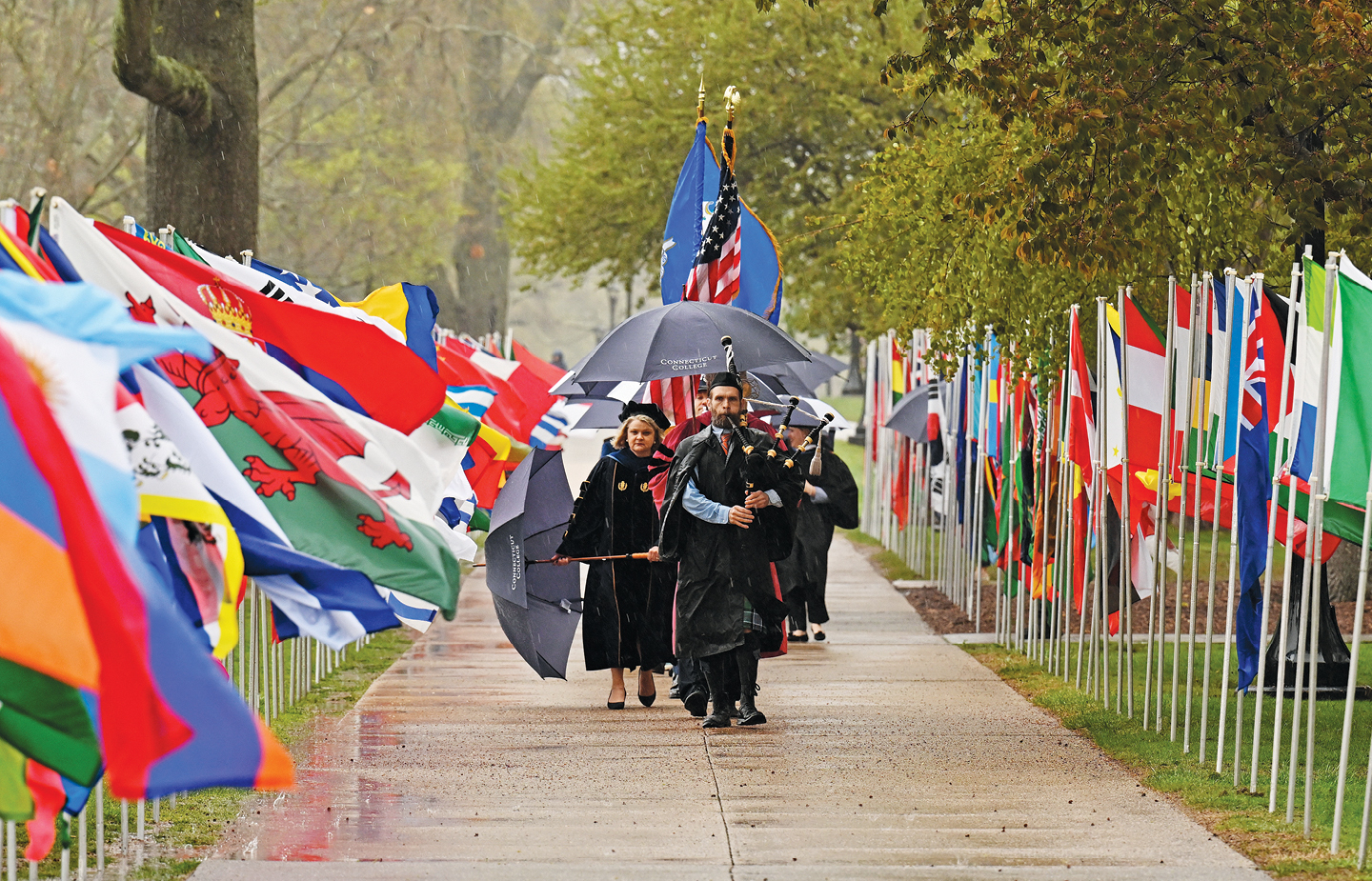 A bagpiper leads the procession into Inauguration on a rainy day