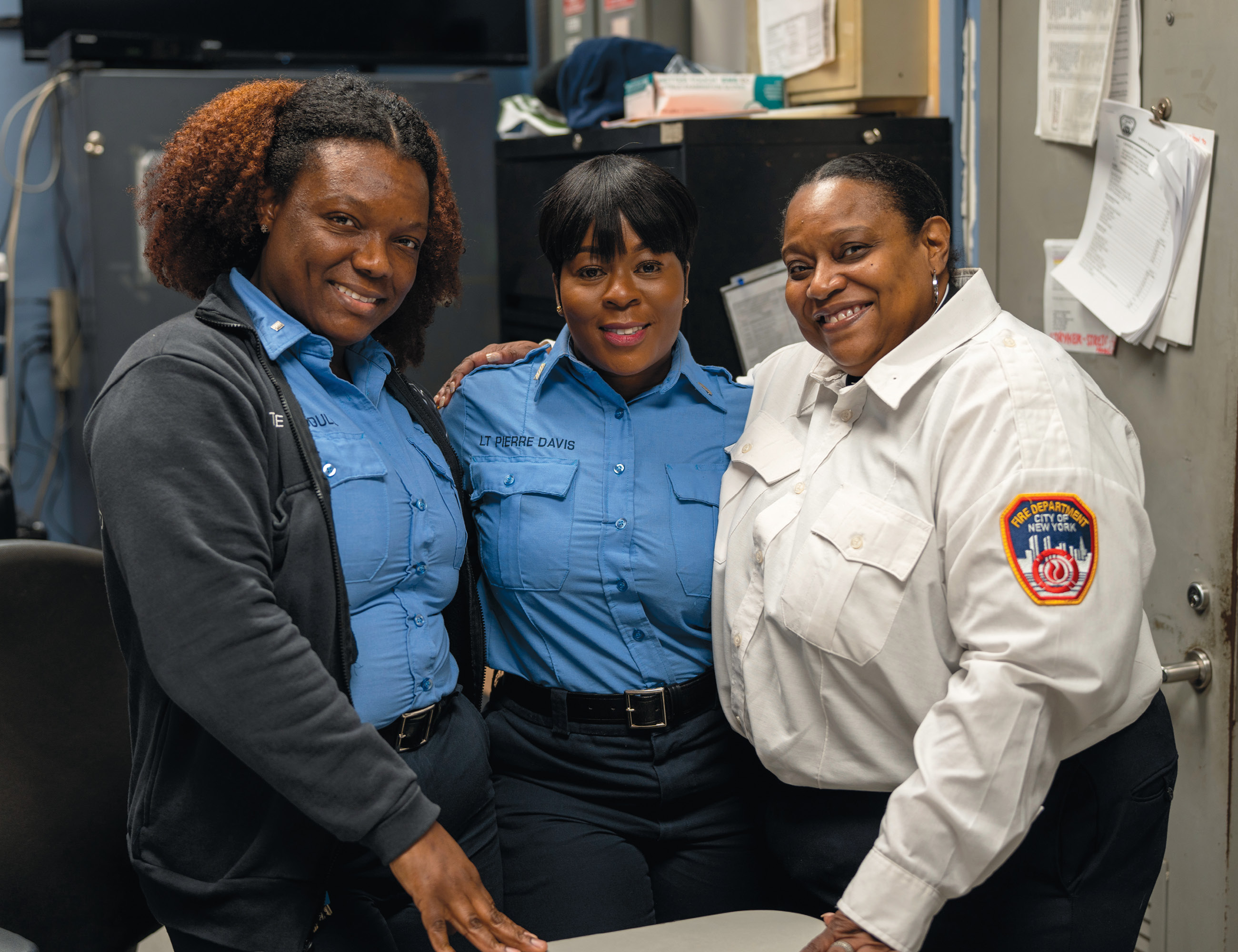 The Rev. Pamela Holmes ’89, far right, with two members of FDNY.