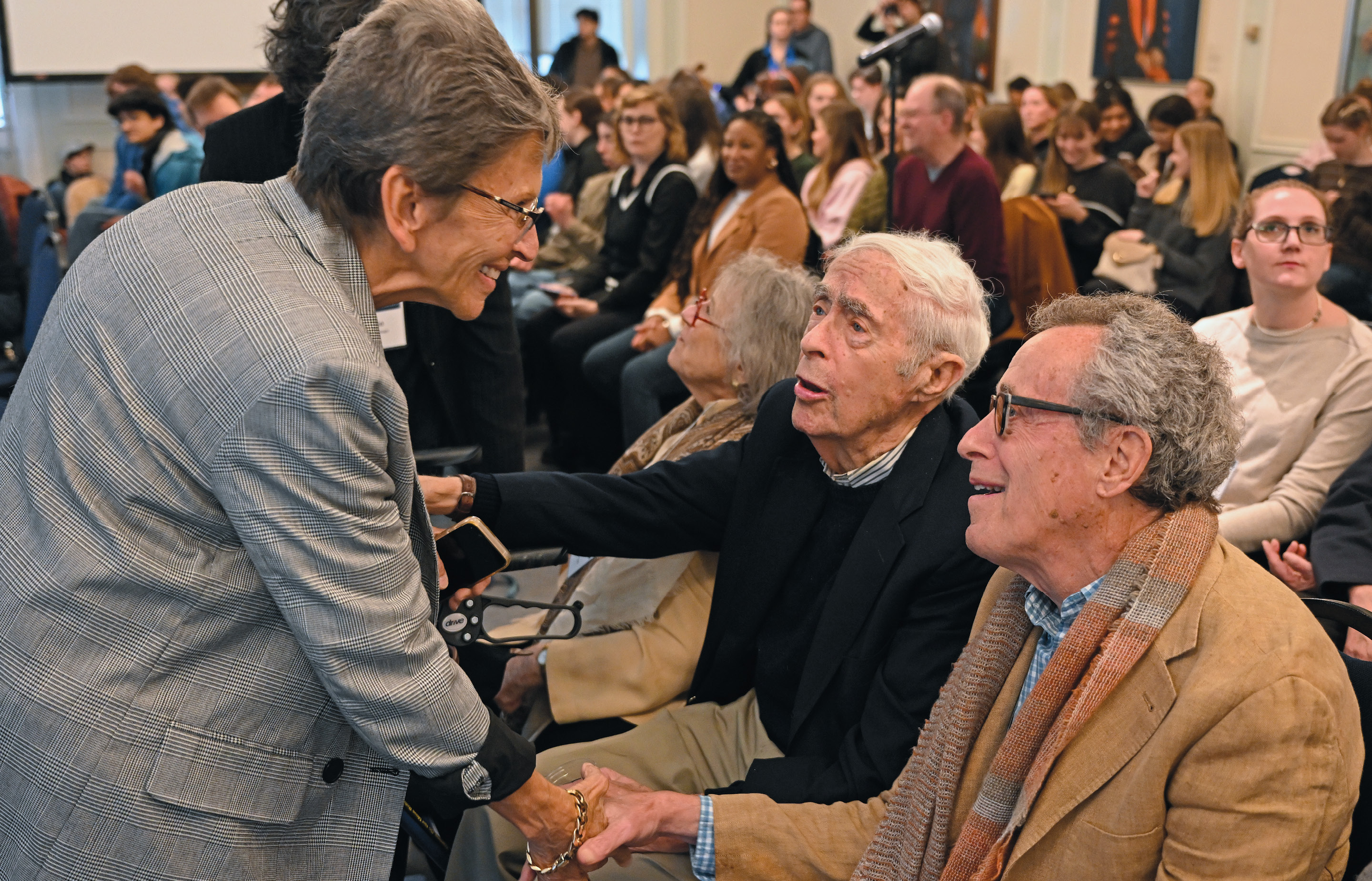 Picture of Blanche Boyd greetings guests at a Klagsbrun Symposium event in 2024