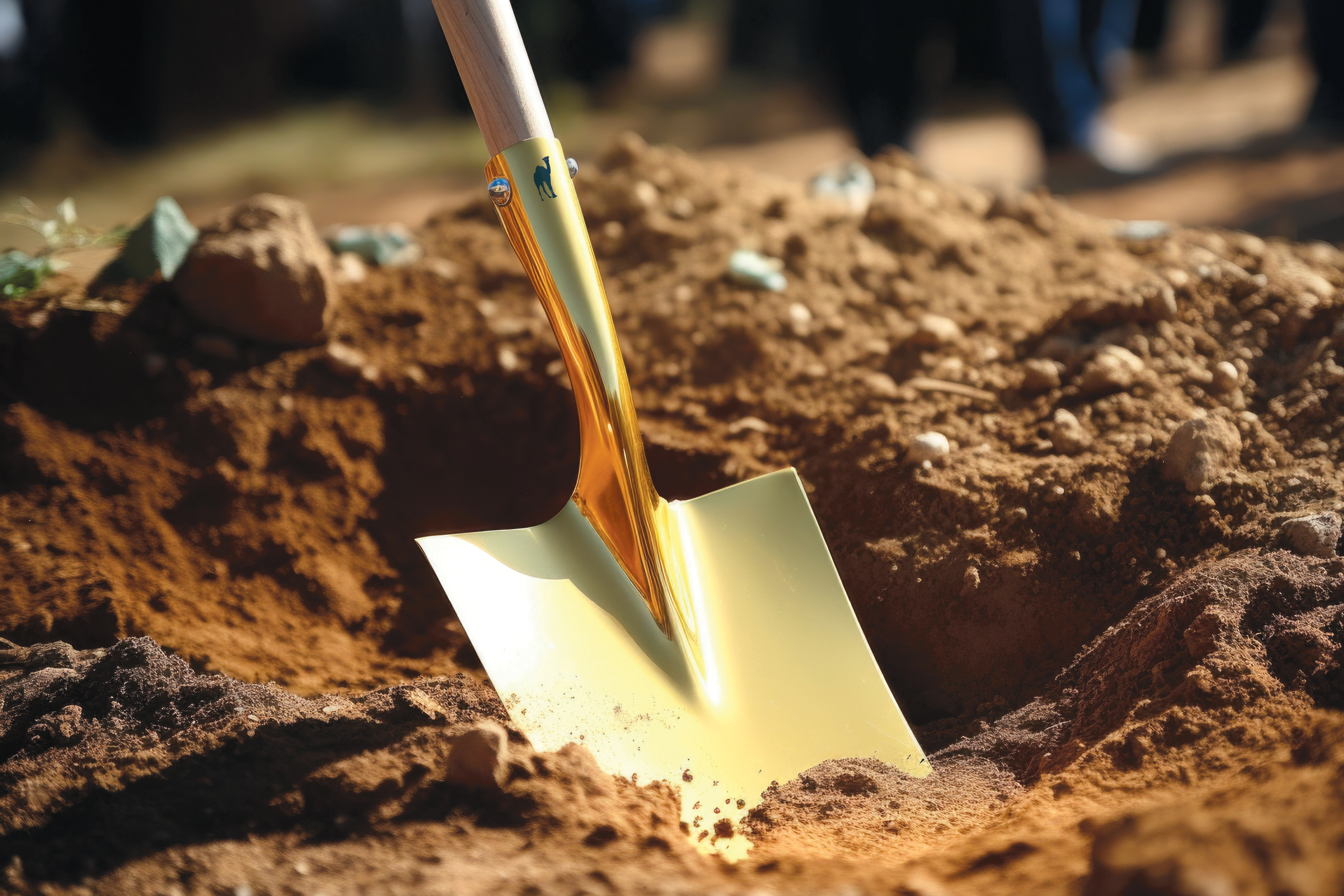 Image of gold shovel digging in the dirt