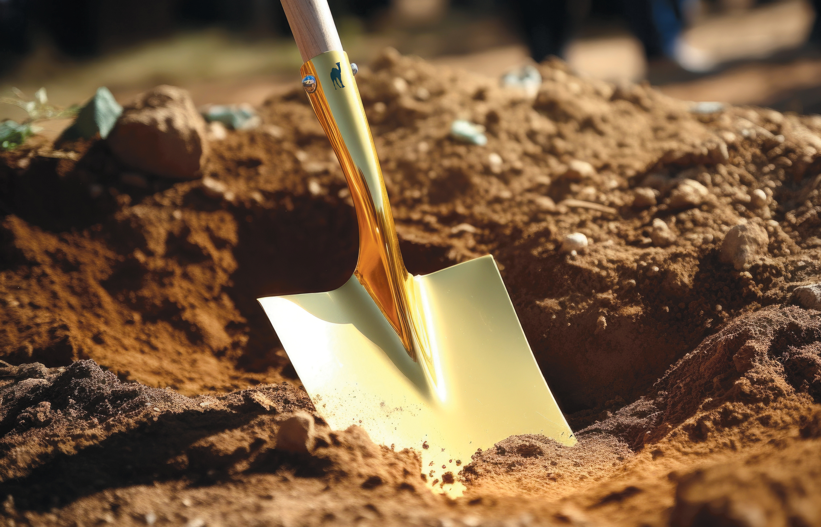 Image of gold shovel digging in the dirt