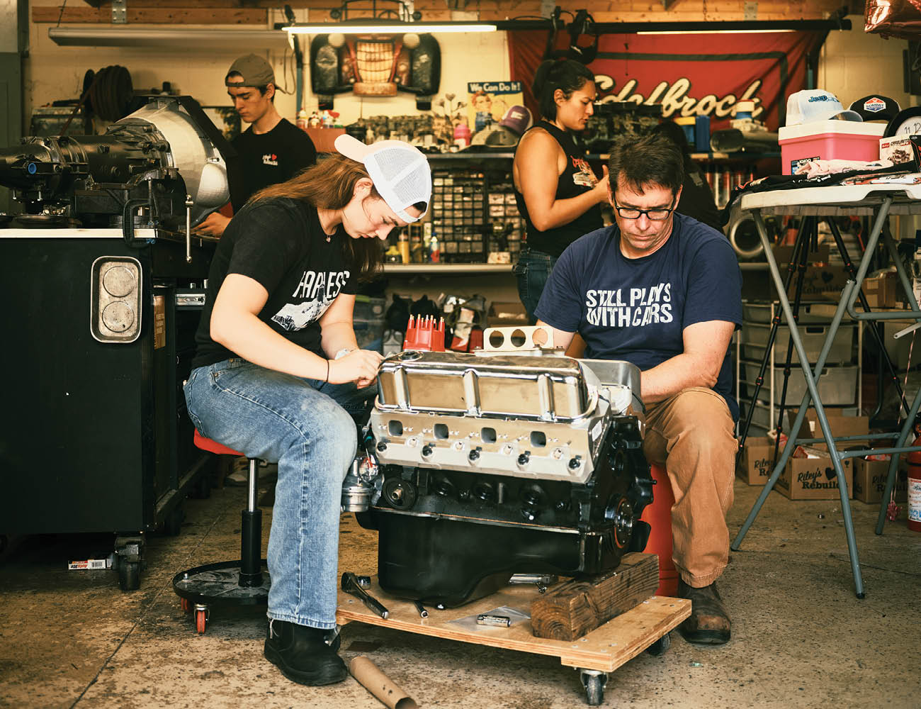 Riley Schlick-Trask ’27 and her father, Dane Trask, work on a Ford small-block V8 engine.
