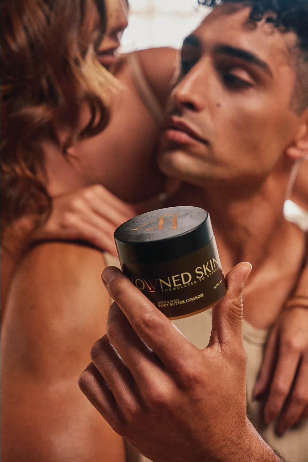 Image of models holding Crowned Skin product