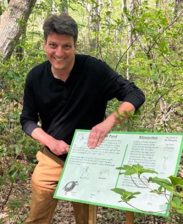 Photo of Scott D'Agostino installing an interpretive sign
