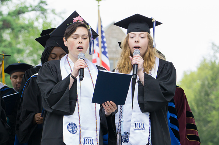 Anna McGregor and MaryClare McDonough lead the crowd in a performance of the alma mater.
