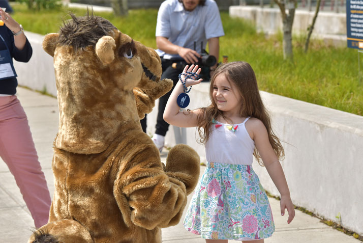 Camel mascot with young girl