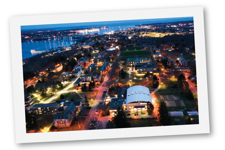 Polaroid-style nighttime aerial view of campus
