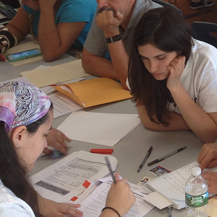Margie Giacalone ’19 helps clients fill out paperwork at an Immigration Advocacy and Support Center clinic in New London, Conn.