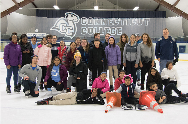 Conn students and faculty pose with participants of Conn's Learn to Skate program. 