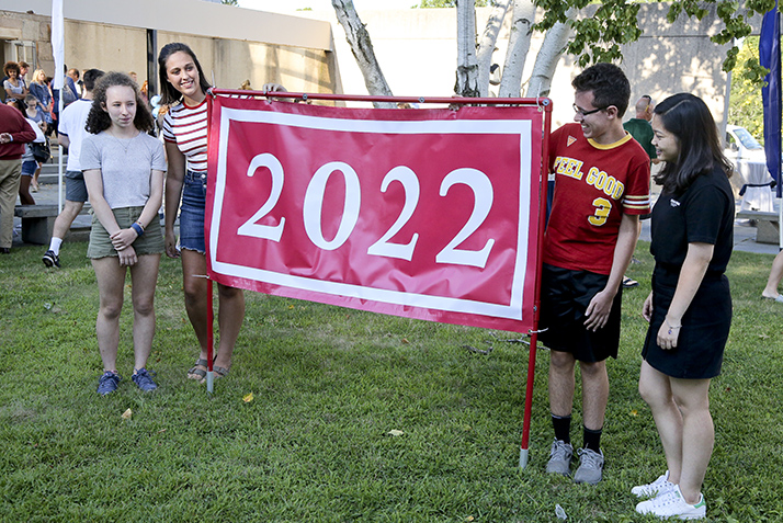 Four members of the Class of 2022 hold the Class of 2022 banner.