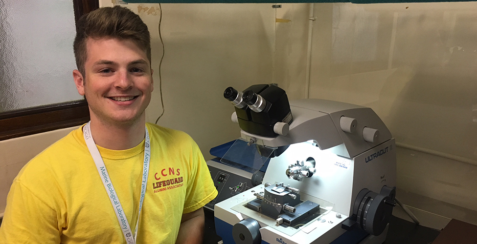 Marc Klepacki '19 poses with equipment at the Woods Hole Marine Biological Laboratory