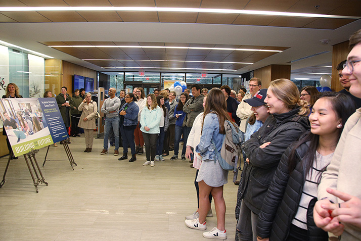 People gather in the lobby of Shain Library.