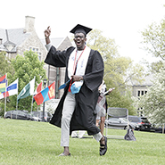 A graduate celebrates before he receives his diploma