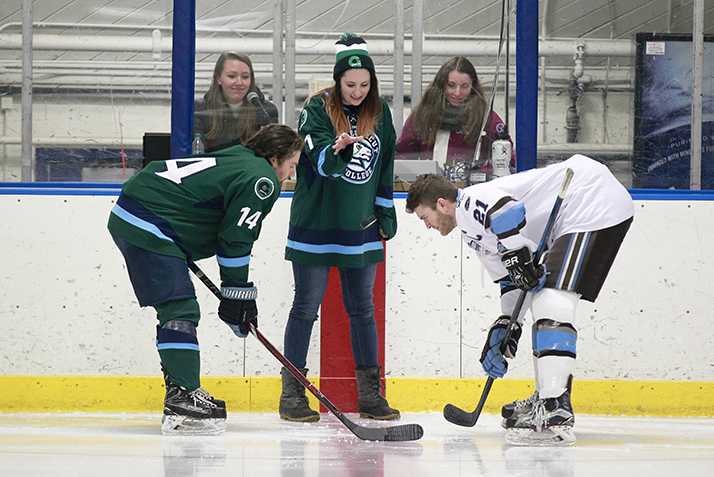 A ceremonial green puck drop at the start of the Green Dot Hockey Game.