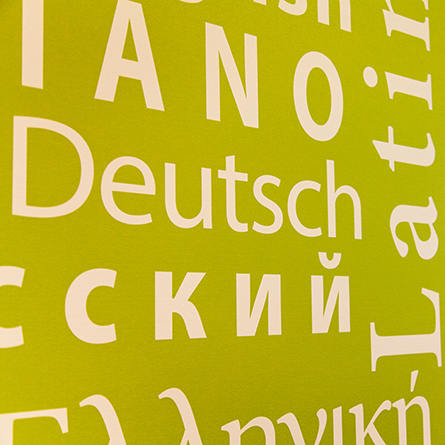 A close up of a Walter Commons wall with words in different languages.